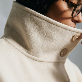 Gros plan sur les boutons et col montant du manteau cape